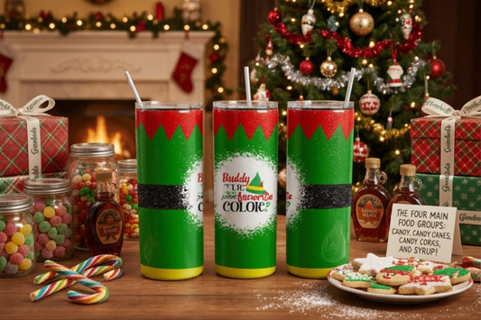 Three festive holiday tumblers with Elf on a Log designs are displayed on a wooden table in a cozy Christmas setting with a decorated tree, fireplace, candy canes, and cookies.