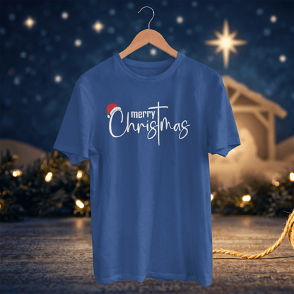 A royal blue short-sleeve t-shirt on a wooden hanger, featuring a 'merry Christmas' graphic with a small red Santa hat, set against a festive Christmas night background with lights and a star.