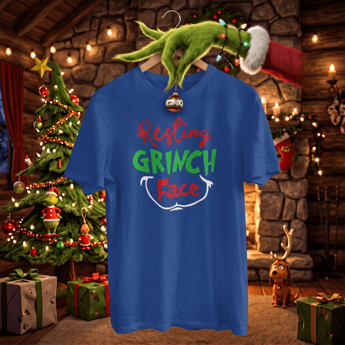 A blue graphic t-shirt featuring the text 'Resting GRINCH Face' in red, green, and white, hanging on a wooden hanger. The hanger is held by the green Grinch hand with a Santa hat, set against a cozy Christmas-themed background with a decorated tree, fireplace, and gifts.