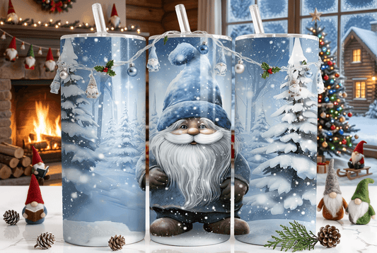 Three tall cylindrical candles with clear lids are decorated with a festive Christmas gnome and snowy forest design. The candles are styled on a tabletop with pinecones and greenery, with a cozy holiday background featuring a lit fireplace, a decorated Christmas tree, and a cabin window.